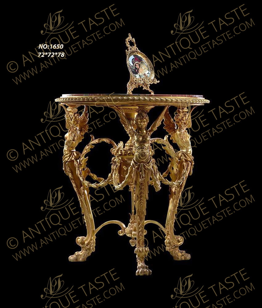 Italian early 19th century Louis XV style fine cast gilt-ormolu center table, the circular marble top inset a beaded frieze raised above three fine winged caryatids connected with laurel circular garlands terminating with acanthus leaves and sea shells attached to a central pendant support cone of prosperity with a column extended below to a leafy pine cone finial issuing a scrolled x-stretcher connects the three legs, The S shape turning legs stand on leafy paw feet